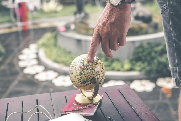person holding brown desk globe
